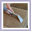 Upholstered chair being professionally cleaned